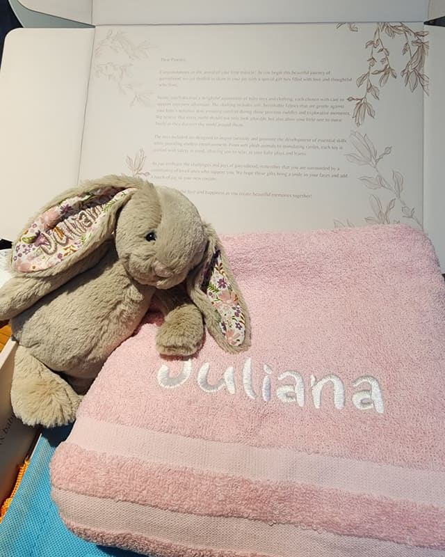 A pink towel embroidered Juliana with a personalised Jellycat bunny
