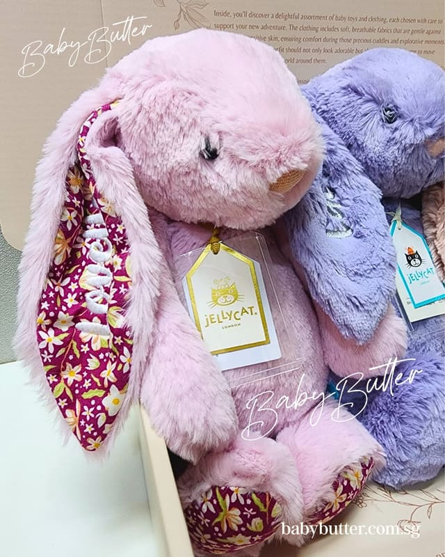 Blush and lilac Jellycat bunnies with Jellycat tags in a gift box