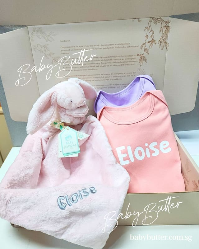 A gift box with a named bunny comforter and a romper printed with Eloise