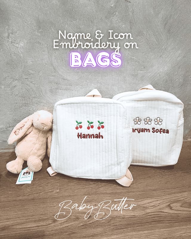 Two quilted bags embroidered with names and little icons